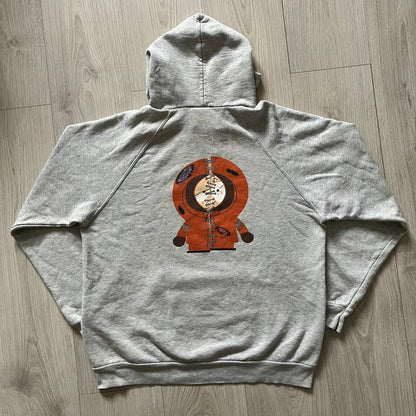South Park “Stitched Up Kenny” Hoodie from 1998 in Gray, made on a Screen Stars blank. Features a small South Park logo on the chest and a large stitched-up Kenny graphic on the back. Vintage licensed piece from the show’s early era.