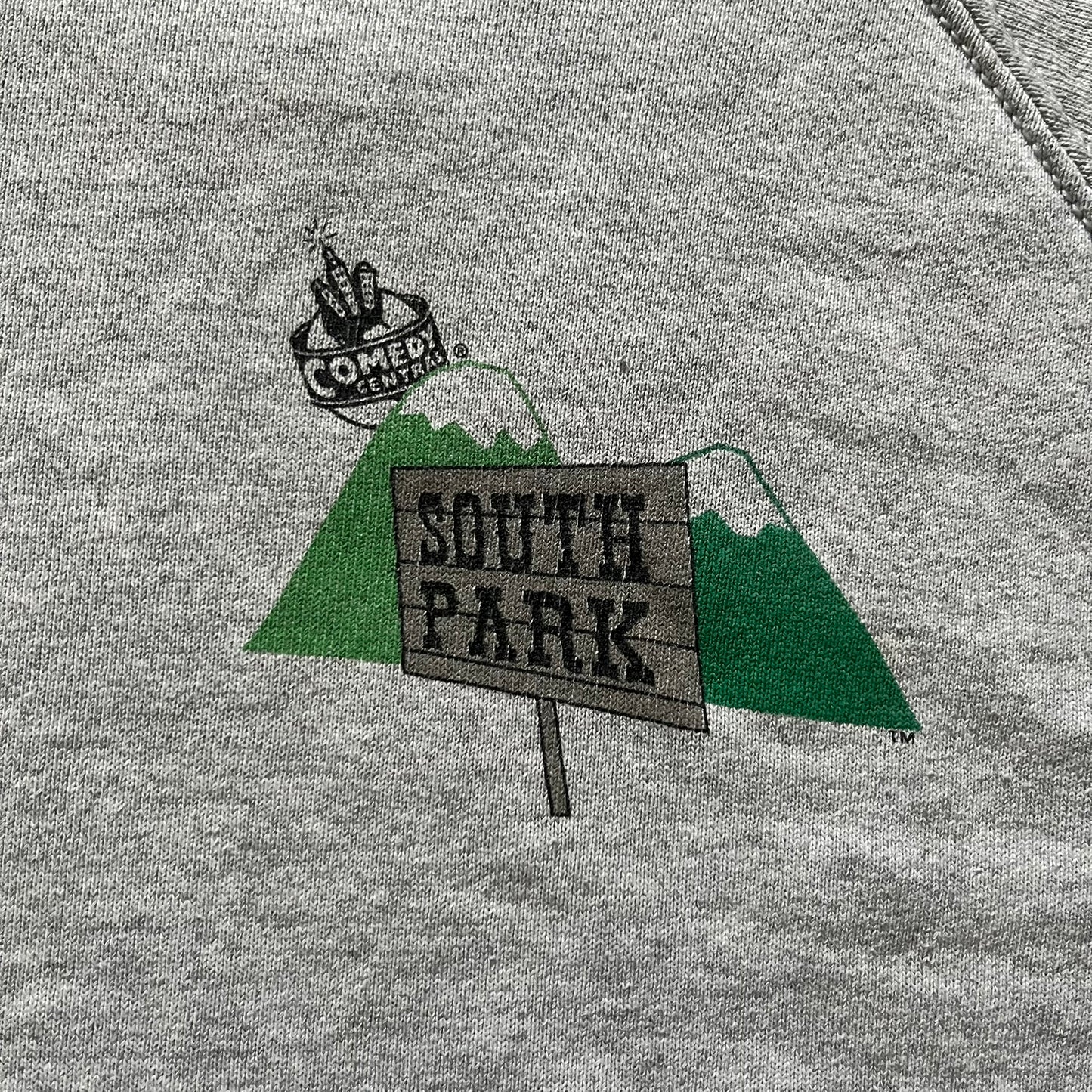 South Park “Stitched Up Kenny” Hoodie from 1998 in Gray, made on a Screen Stars blank. Features a small South Park logo on the chest and a large stitched-up Kenny graphic on the back. Vintage licensed piece from the show’s early era.