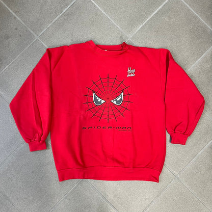 Spider-Man 2002 Hoop Cola Promo Red Crewneck is a rare Poland-exclusive crewneck made for the cross-promotional campaign between Hoop Cola and Warner Bros for the Spider-Man (2002) film. It was never sold in stores and was given out only as a prize in the SMS code contest. The cotton crewneck features web with eyes graphic in the middle, Spider-Man logo under and a Hoop Cola logo above.