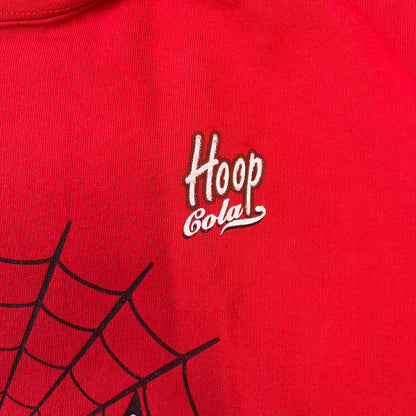 Spider-Man 2002 Hoop Cola Promo Red Crewneck is a rare Poland-exclusive crewneck made for the cross-promotional campaign between Hoop Cola and Warner Bros for the Spider-Man (2002) film. It was never sold in stores and was given out only as a prize in the SMS code contest. The cotton crewneck features web with eyes graphic in the middle, Spider-Man logo under and a Hoop Cola logo above.