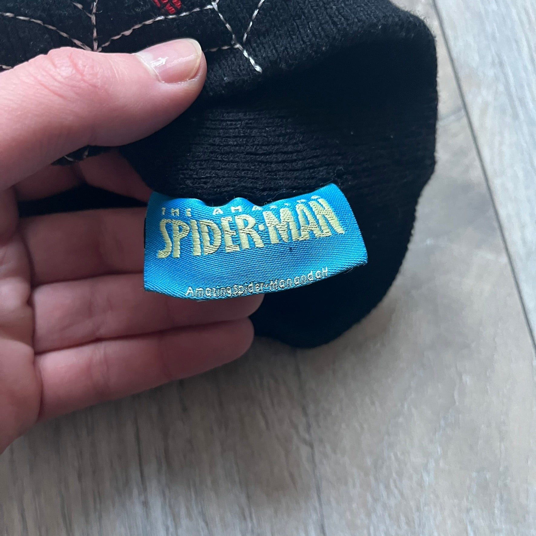 This vintage 2006 Spider-Man beanie by Contrast comes in black and features an embroidered design of Spider-Man on a web with “The Amazing Spider-Man” text. Officially licensed, it’s a nostalgic collectible that captures the mid-2000s comic and pop culture era.