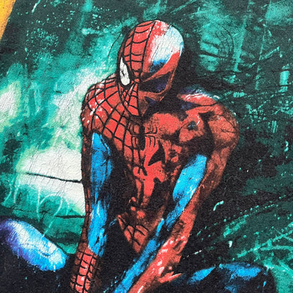 Spider-Man Marvel Timestorm 2009–2099 Tee is a black T-shirt featuring the Timestorm 2009–2099 cover graphic. The print shows Spider-Man half in his classic design and half in the 2099 version, sitting with a blurred green city background. Made by Marvel Mad Engine, the shirt highlights the multiversal crossover design.