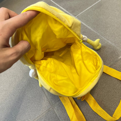SpongeBob SquarePants 2010 Backpack is designed in the shape of SpongeBob’s body with embroidered facial details, a 3D nose, and loose hanging arms and legs. It features one main compartment and a yellow 2010 licensed tag on the side.
