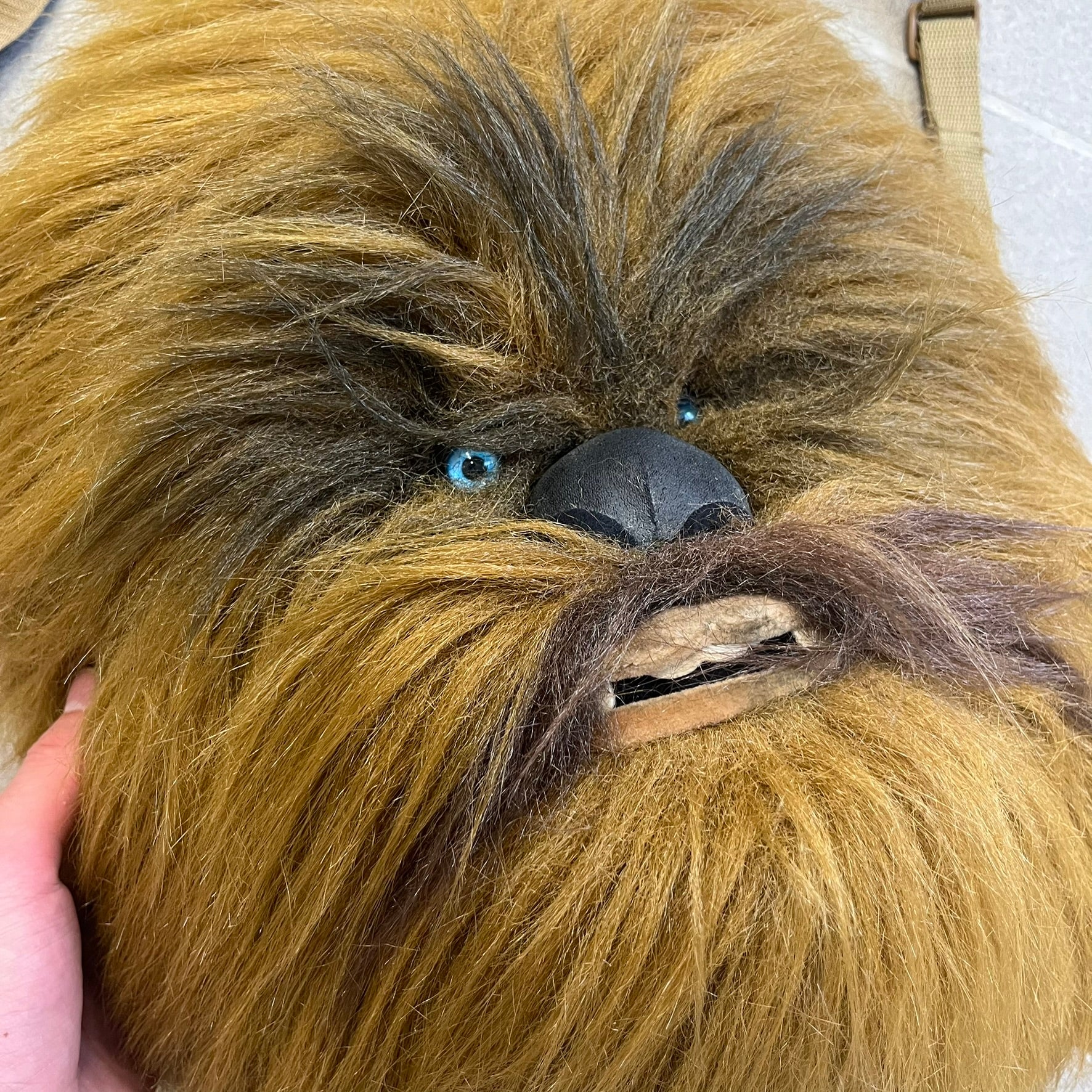  Star Wars 1990s Chewbacca Head Backpack is a novelty bag designed in the shape of Chewbacca’s head. The exterior features a furry construction with plastic eyes and a leather-like nose and mouth. It includes an adjustable shoulder straps, a single main compartment and a red Star Wars licensed tag.
