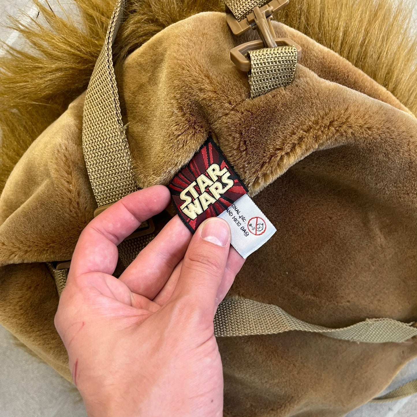  Star Wars 1990s Chewbacca Head Backpack is a novelty bag designed in the shape of Chewbacca’s head. The exterior features a furry construction with plastic eyes and a leather-like nose and mouth. It includes an adjustable shoulder straps, a single main compartment and a red Star Wars licensed tag.