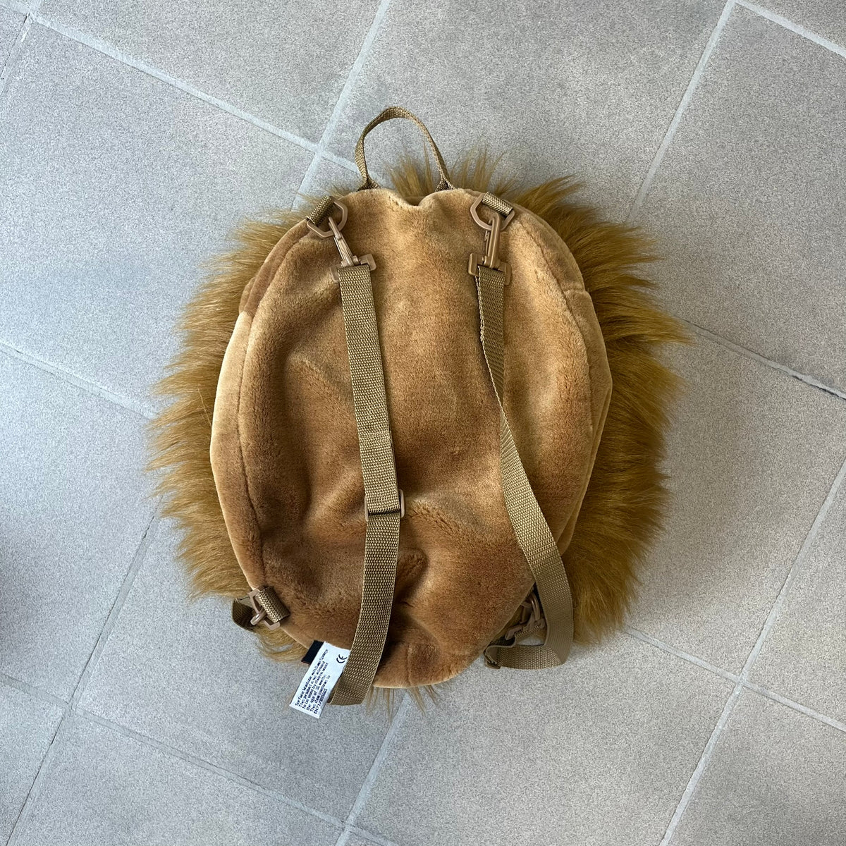 Star Wars 1990s Chewbacca Head Backpack is a novelty bag designed in the shape of Chewbacca’s head. The exterior features a furry construction with plastic eyes and a leather-like nose and mouth. It includes an adjustable shoulder straps, a single main compartment and a red Star Wars licensed tag.