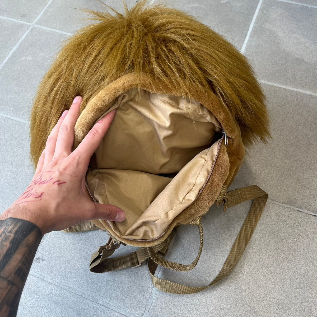 Star Wars 1990s Chewbacca Head Backpack is a novelty bag designed in the shape of Chewbacca’s head. The exterior features a furry construction with plastic eyes and a leather-like nose and mouth. It includes an adjustable shoulder straps, a single main compartment and a red Star Wars licensed tag.
