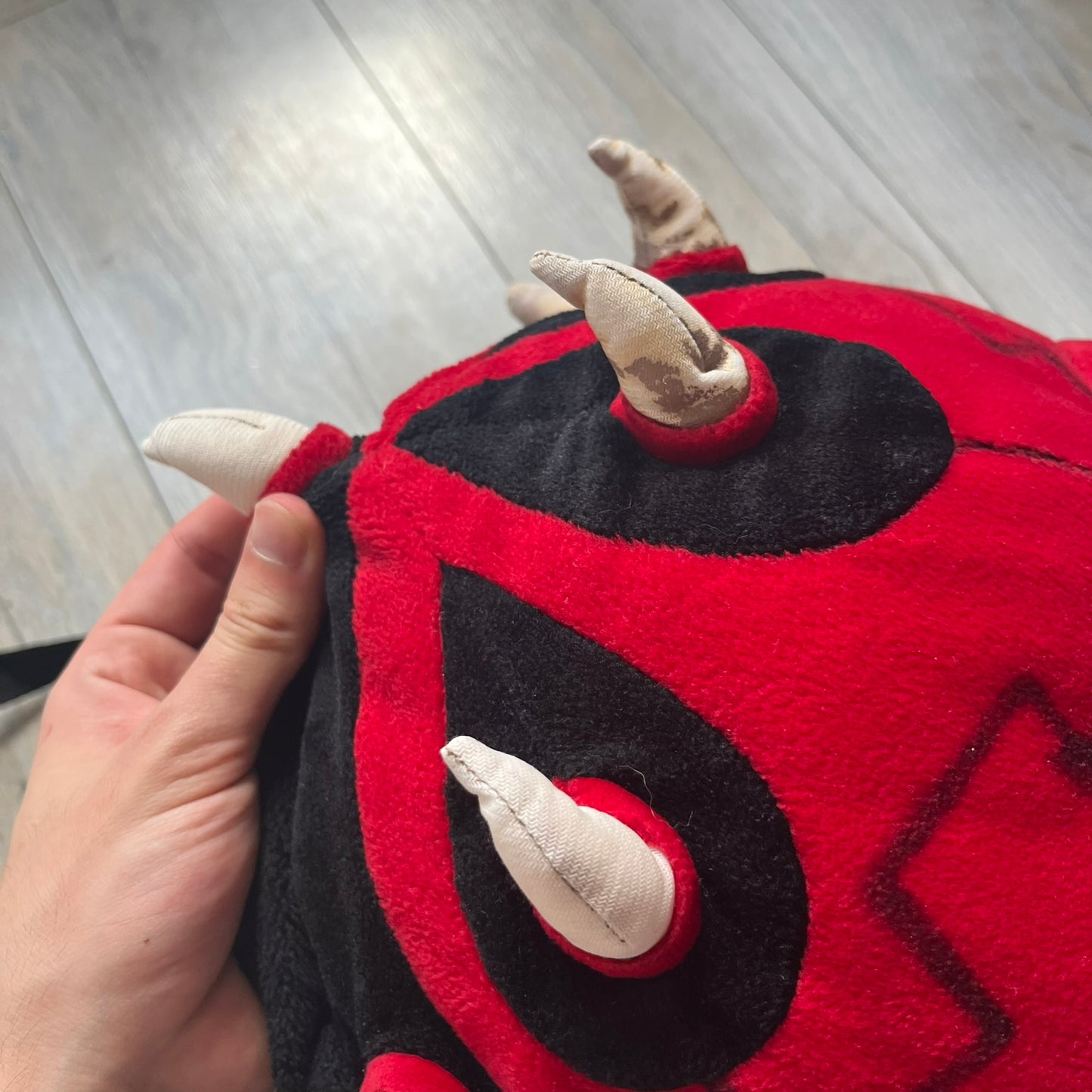 Star Wars 90's Darth Maul Head Backpack is a plush backpack shaped like Darth Maul’s head with striking red-and-black detailing and realistic plastic eyes. Features a small zip compartment on the back and adjustable straps, perfect as a collectible or standout accessory.