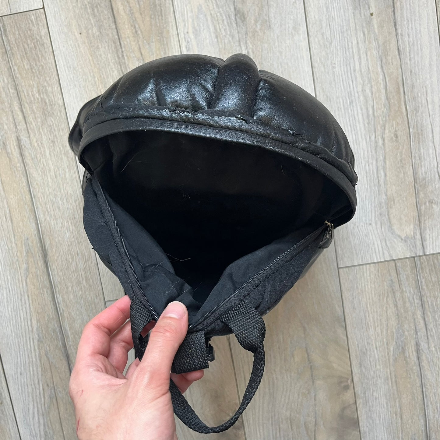 Star Wars 1990s Darth Vader Head Backpack is a vintage backpack shaped like Darth Vader’s helmet. It is finished in shiny black with molded plastic details recreating the character’s mask and helmet. The bag has one main compartment and includes a red Star Wars licensed tag from the 1990s.
