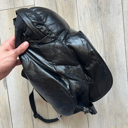 Star Wars 1990s Darth Vader Head Backpack is a vintage backpack shaped like Darth Vader’s helmet. It is finished in shiny black with molded plastic details recreating the character’s mask and helmet. The bag has one main compartment and includes a red Star Wars licensed tag from the 1990s.
