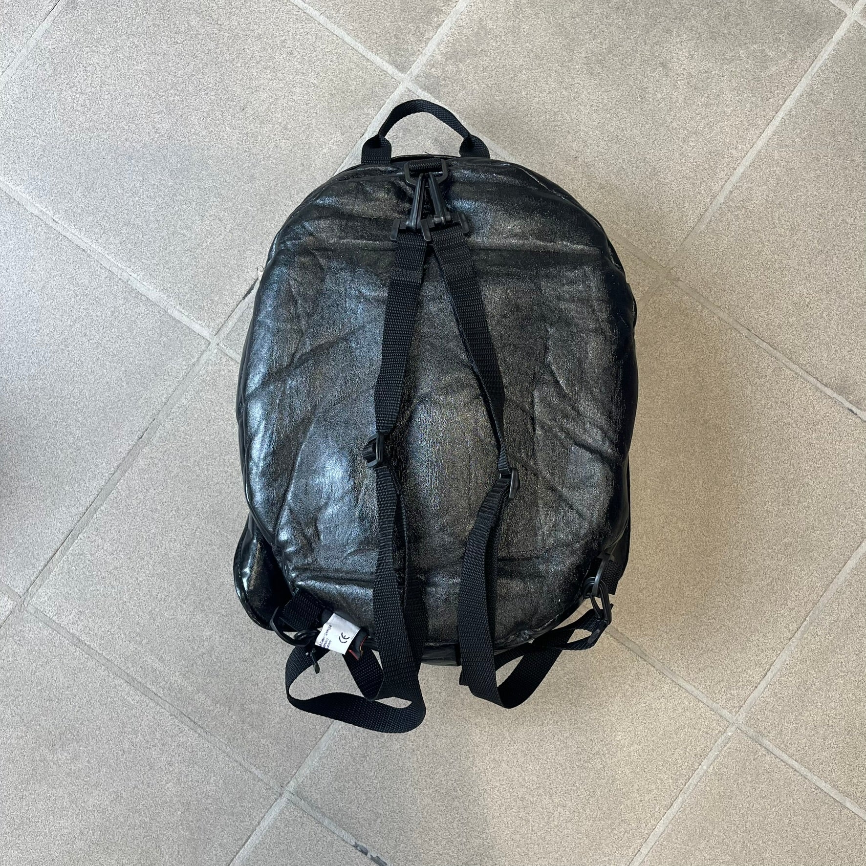 Star Wars 1990s Darth Vader Head Backpack is a vintage backpack shaped like Darth Vader’s helmet. It is finished in shiny black with molded plastic details recreating the character’s mask and helmet. The bag has one main compartment and includes a red Star Wars licensed tag from the 1990s.