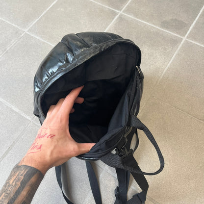 Star Wars 1990s Darth Vader Head Backpack is a vintage backpack shaped like Darth Vader’s helmet. It is finished in shiny black with molded plastic details recreating the character’s mask and helmet. The bag has one main compartment and includes a red Star Wars licensed tag from the 1990s.