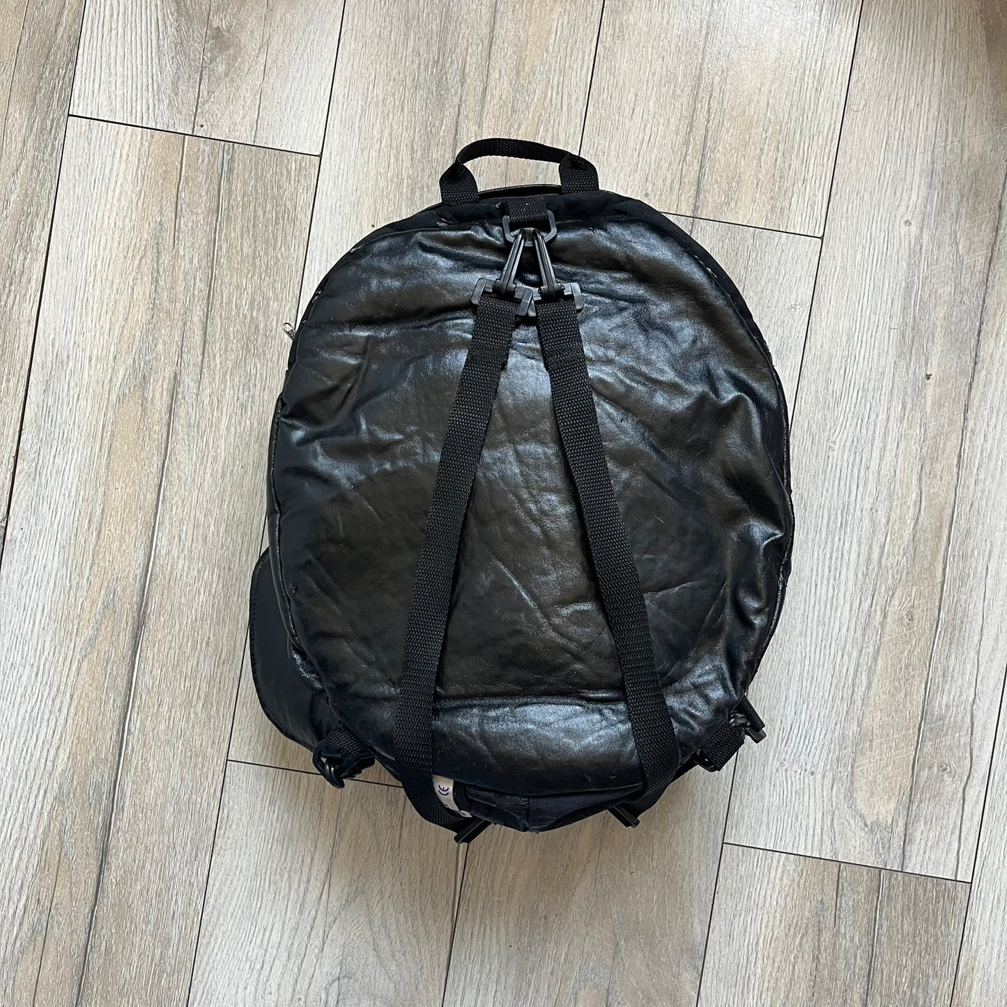 Star Wars 1990s Darth Vader Head Backpack is a vintage backpack shaped like Darth Vader’s helmet. It is finished in shiny black with molded plastic details recreating the character’s mask and helmet. The bag has one main compartment and includes a red Star Wars licensed tag from the 1990s.
