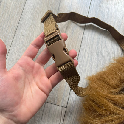 Star Wars 1990s Chewbacca Head Shoulder Bag is a novelty shoulder bag designed in the shape of Chewbacca’s head. The exterior features a furry construction with plastic eyes and a leather-like nose and mouth. It includes an adjustable shoulder strap, a single main compartment, a red Star Wars licensed tag, and the original paper tag.