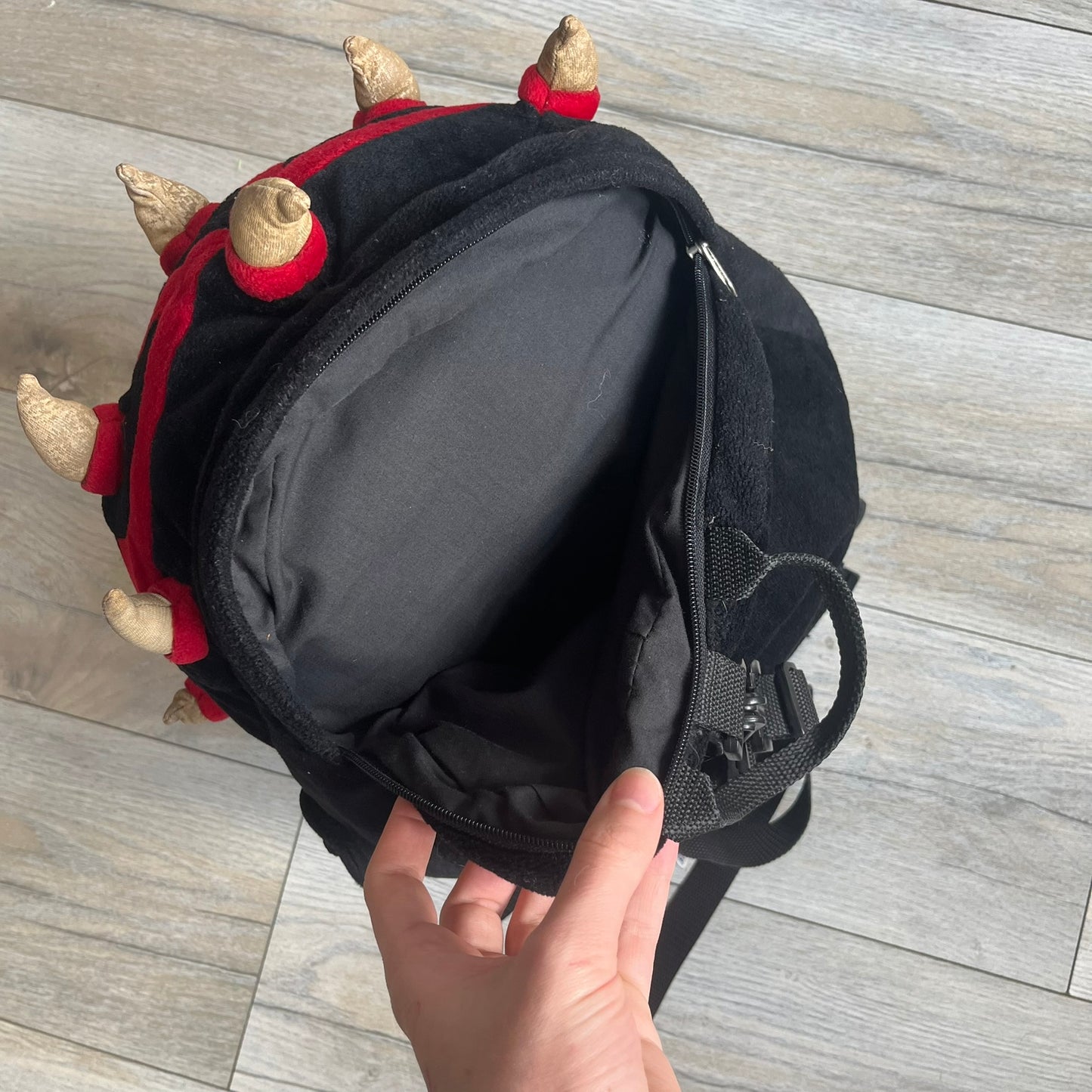 Star Wars 90's Darth Maul Head Backpack is a plush backpack shaped like Darth Maul’s head with striking red-and-black detailing and realistic plastic eyes. Features a small zip compartment on the back and adjustable straps, perfect as a collectible or standout accessory.