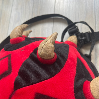 Star Wars 90's Darth Maul Head Backpack is a plush backpack shaped like Darth Maul’s head with striking red-and-black detailing and realistic plastic eyes. Features a small zip compartment on the back and adjustable straps, perfect as a collectible or standout accessory.