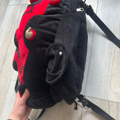 Star Wars 90's Darth Maul Head Backpack is a plush backpack shaped like Darth Maul’s head with striking red-and-black detailing and realistic plastic eyes. Features a small zip compartment on the back and adjustable straps, perfect as a collectible or standout accessory.