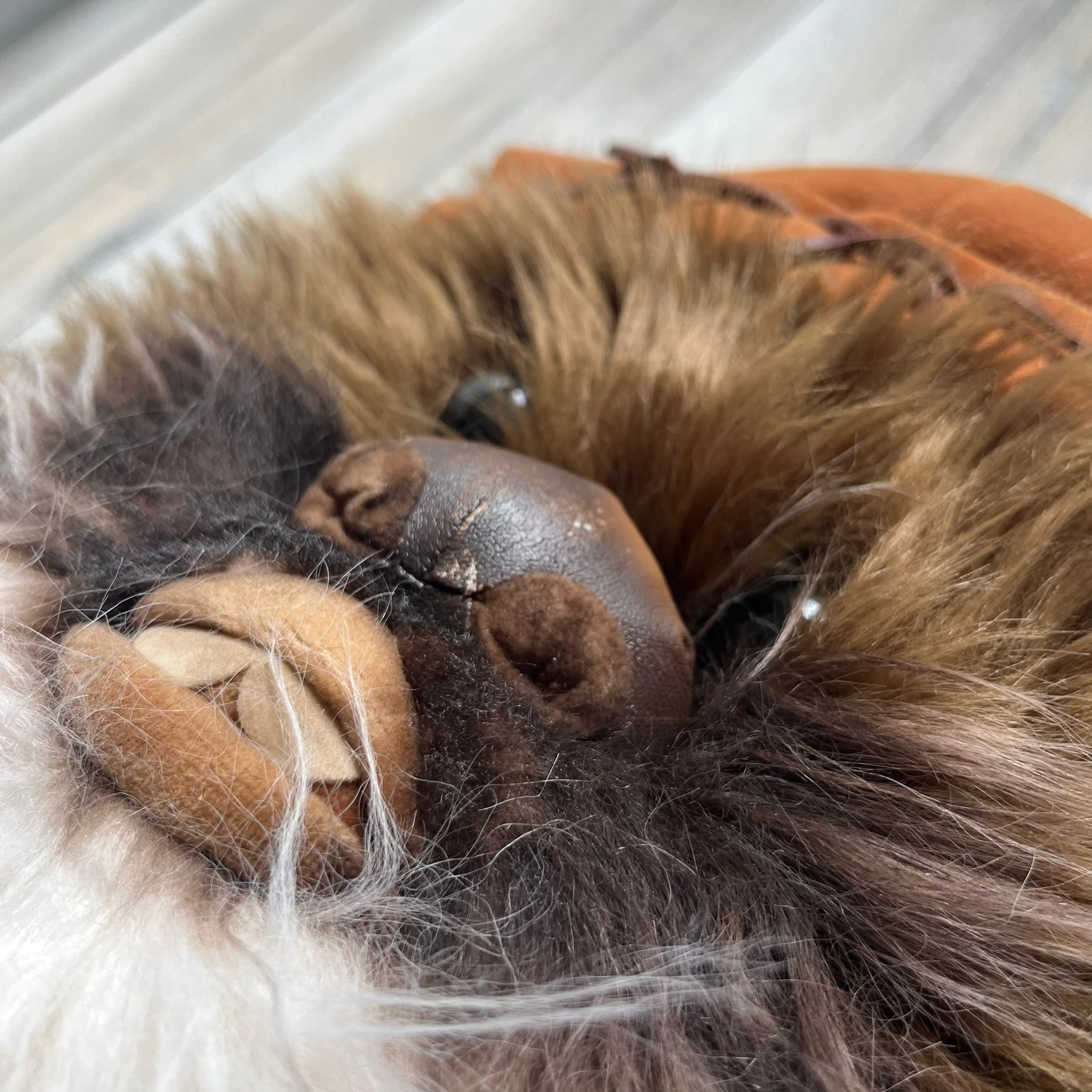 Star Wars 1990s Ewok Wicket Head Backpack is a plush backpack designed in the shape of the Ewok character Wicket W. Warrick. The bag features a brown Ewok face with a white beard and a brown hood, along with green camo-style shoulder straps. It includes a 1990s Star Wars neck tag and original paper tag.