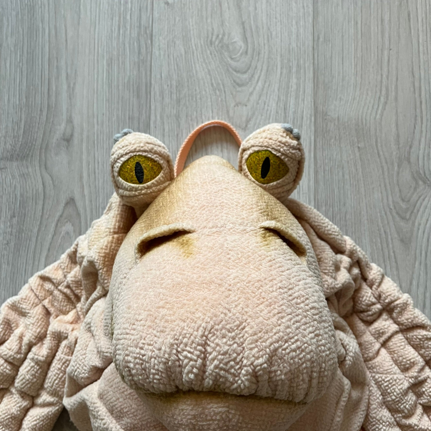 Vintage 1990s Star Wars backpack shaped like Jar Jar Binks’ head, complete with oversized ears for a playful, collectible design. This nostalgic piece captures the quirky charm of the character while offering functional storage. A rare, fun accessory for fans of classic Star Wars memorabilia.