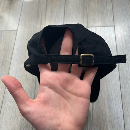 Star Wars Episode I 1990s Black Baseball Cap is a black cotton cap featuring embroidered Star Wars branding on the front in white and gray tones. Beneath it, a smaller “Episode I” embroidery is included for additional detailing. The interior includes a red Star Wars licensed tag, completing the official branded construction.