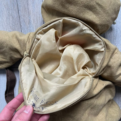 Star Wars Episode III Yoda 2006 Backpack is a character-shaped backpack featuring Yoda dressed in brown pants and a beige-yellow jacket with an attached hood. It includes two standard shoulder straps running from the hands to the feet, plus an additional stabilizing strap attached near the legs. The interior tag shows Star Wars Episode III: Revenge of the Sith branding with 2006 Lucasfilm licensing.