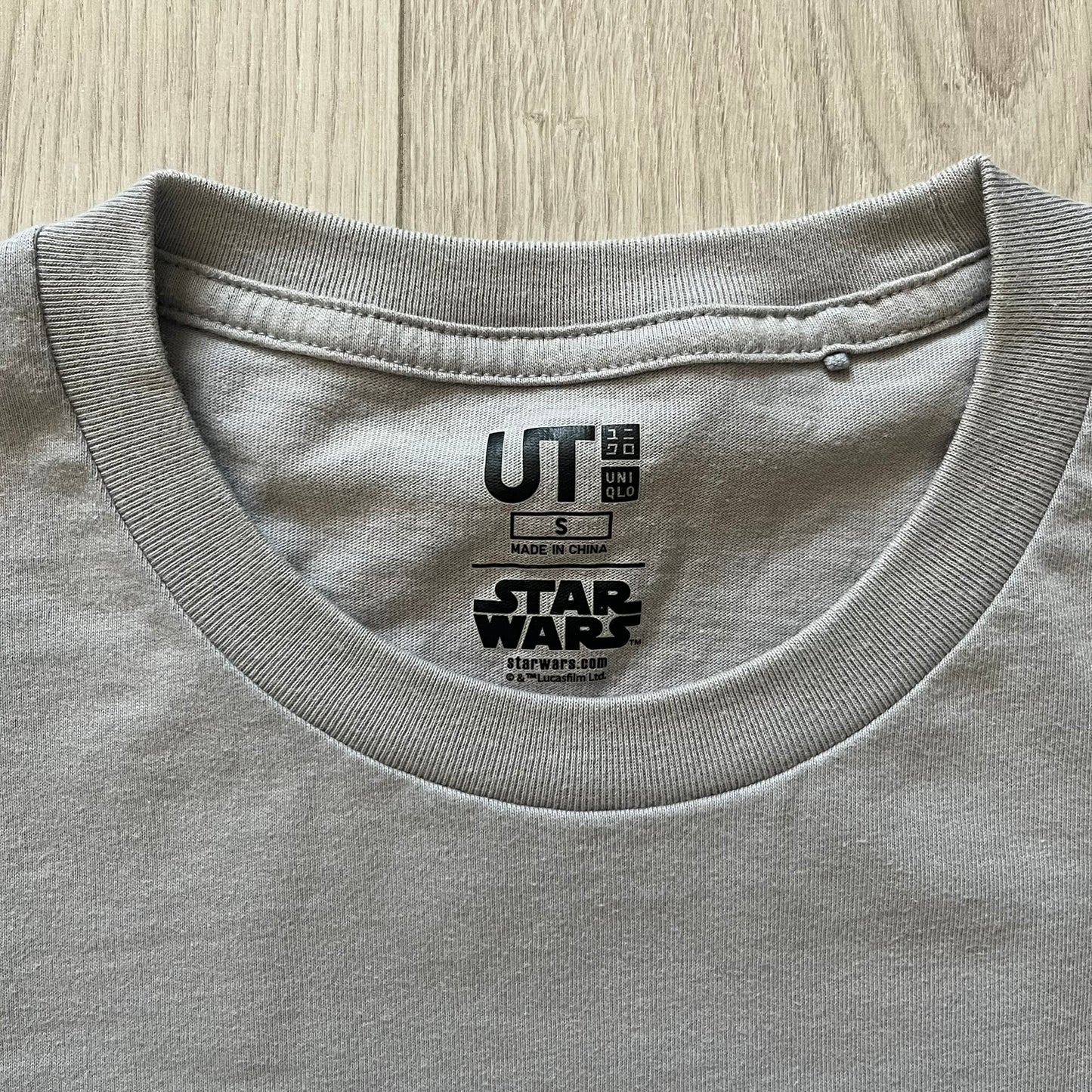 Gray t-shirt with a 'Star Wars' and 'UT' label on the collar.