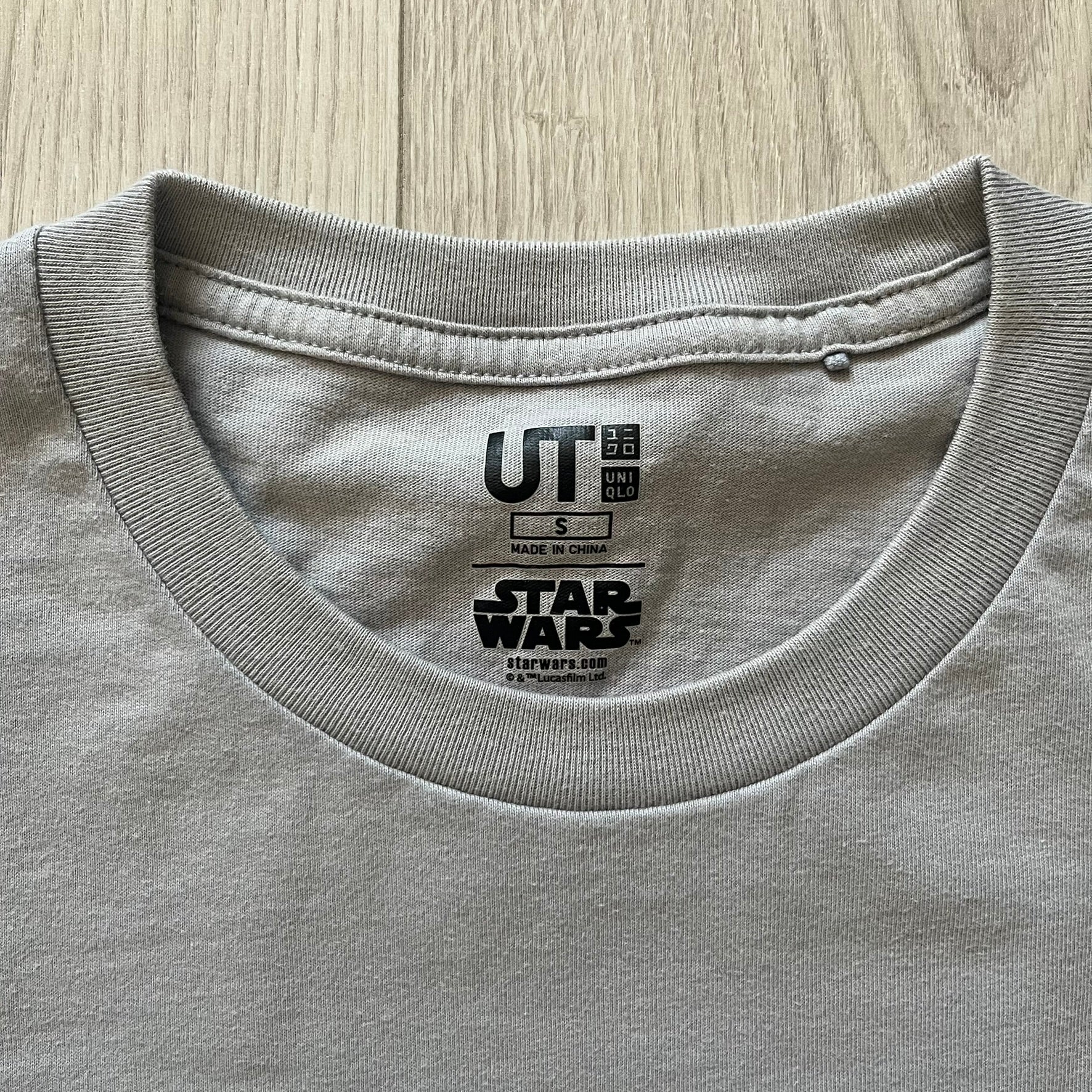 Gray t-shirt with a 'Star Wars' and 'UT' label on the collar.