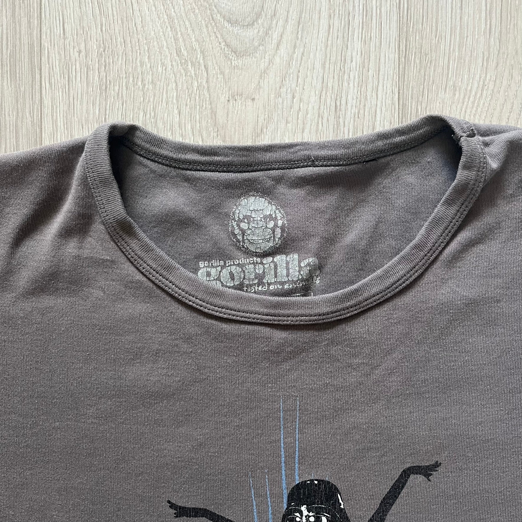 Gray Star Wh*res tee showcasing female figures in Stormtrooper and Vader masks. Logo sits prominently on the chest with witty “Available in Alderaan Places” tagline beneath. A perfect sci-fi parody tee.