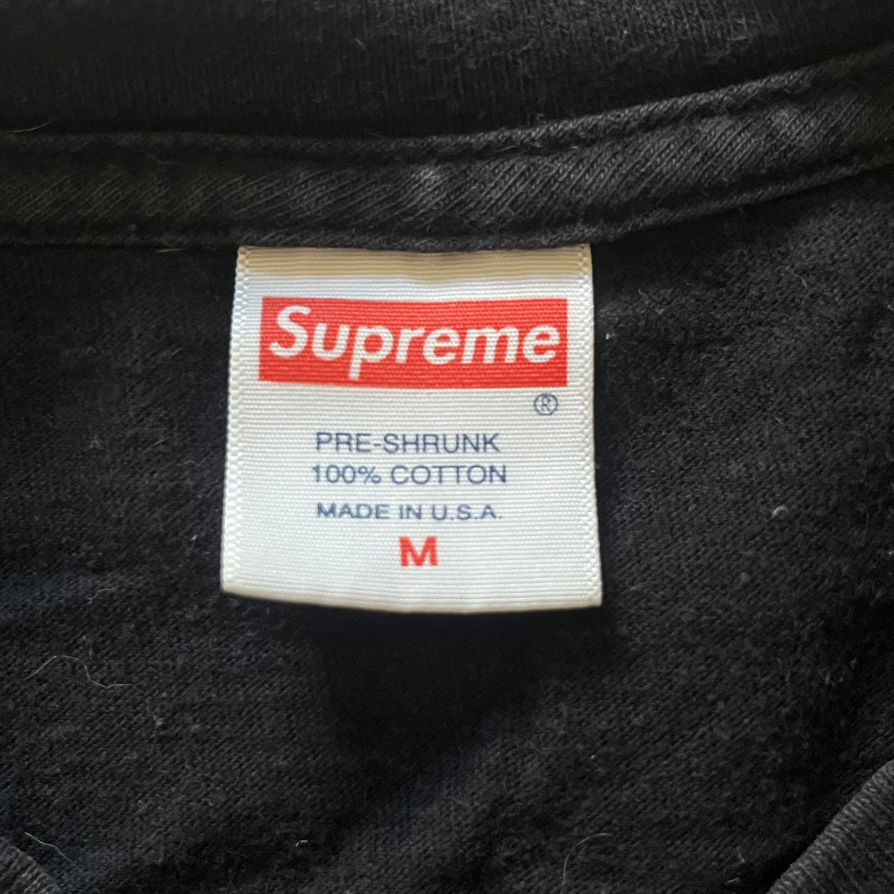 From Supreme’s SS16 Black Sabbath collaboration, the Tome Tee arrives in black with striking purple graphics. The front shows the band’s Children of the Grave artwork within a book, contrasted by a gothic Supreme logo on the back. A sought-after item bridging metal iconography and Supreme’s streetwear legacy.
