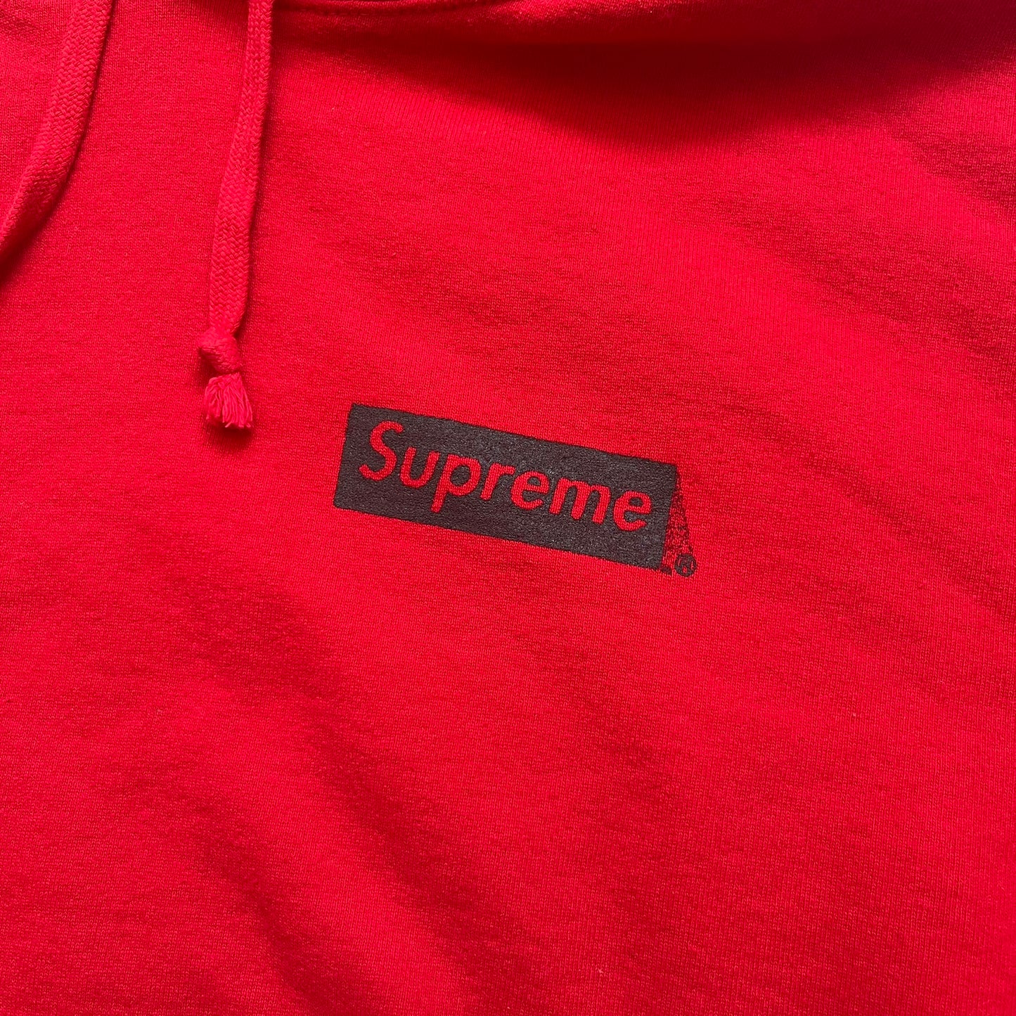 Supreme Catwoman FW23 Hooded Sweatshirt is a red pullover hoodie released on October 19, 2023. It features a drawstring hood, kangaroo pocket, and ribbed cuffs and hem. A small Supreme box logo is placed on the left chest in black.&nbsp;The back features a large Catwoman mask graphic combined with Supreme branding across the width of the design in black and green.