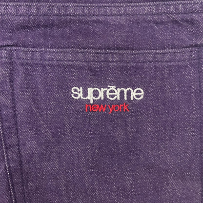 Supreme Denim Purple SS25 Baggy Shorts crafted from 13 oz. all-cotton denim in a purple hue. Features a relaxed baggy fit, classic five-pocket styling, zip fly, copper oxide rivets, and embroidered Supreme New York logo on the back pocket. Durable, stylish, and perfect for everyday streetwear.