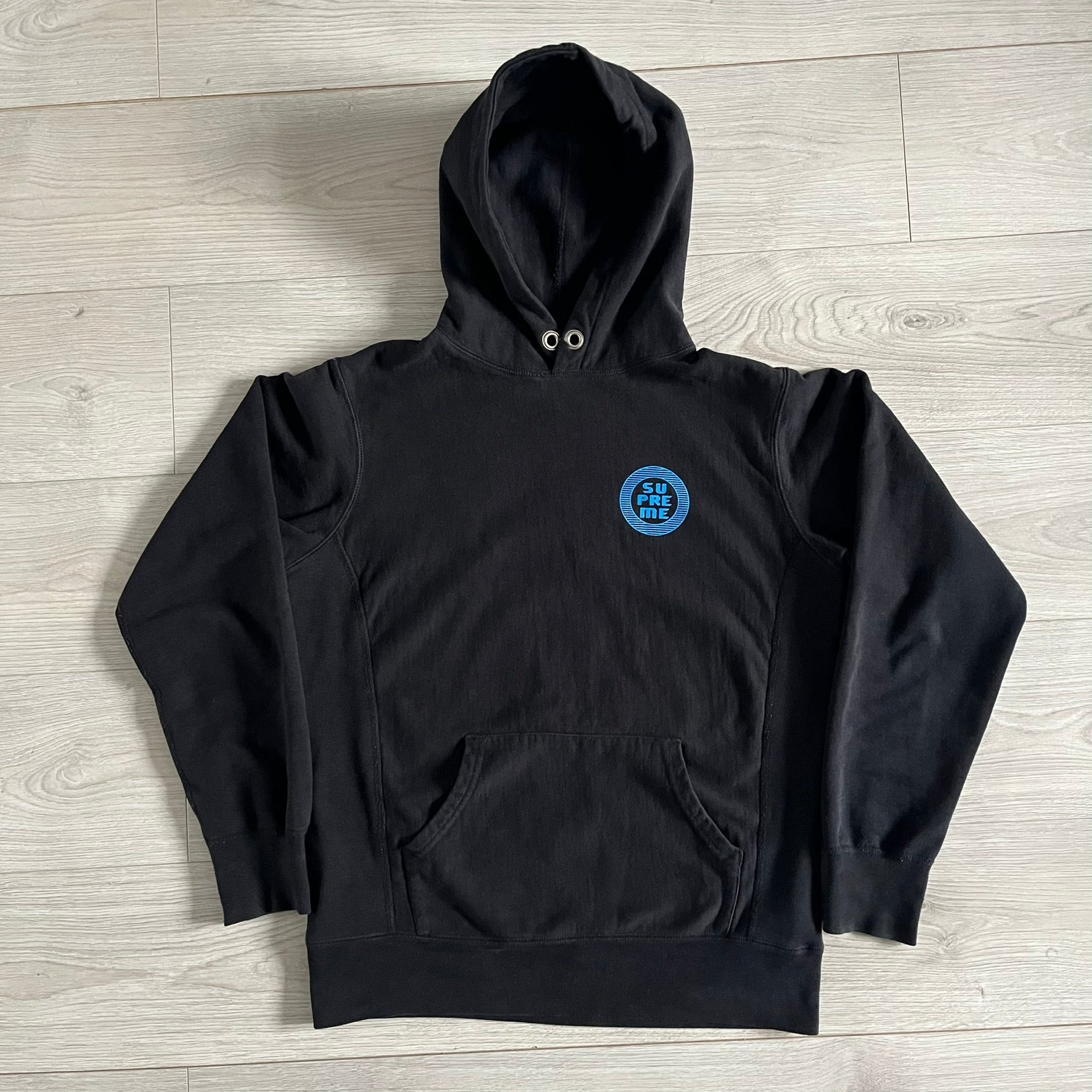 Released in Spring/Summer 2015, the Supreme Disrupt Hoodie in black features a minimalist front logo and a bold oversized back print. Made from 100% cotton, this piece delivers Supreme’s signature streetwear silhouette with durable rib-knit cuffs and hooded design.