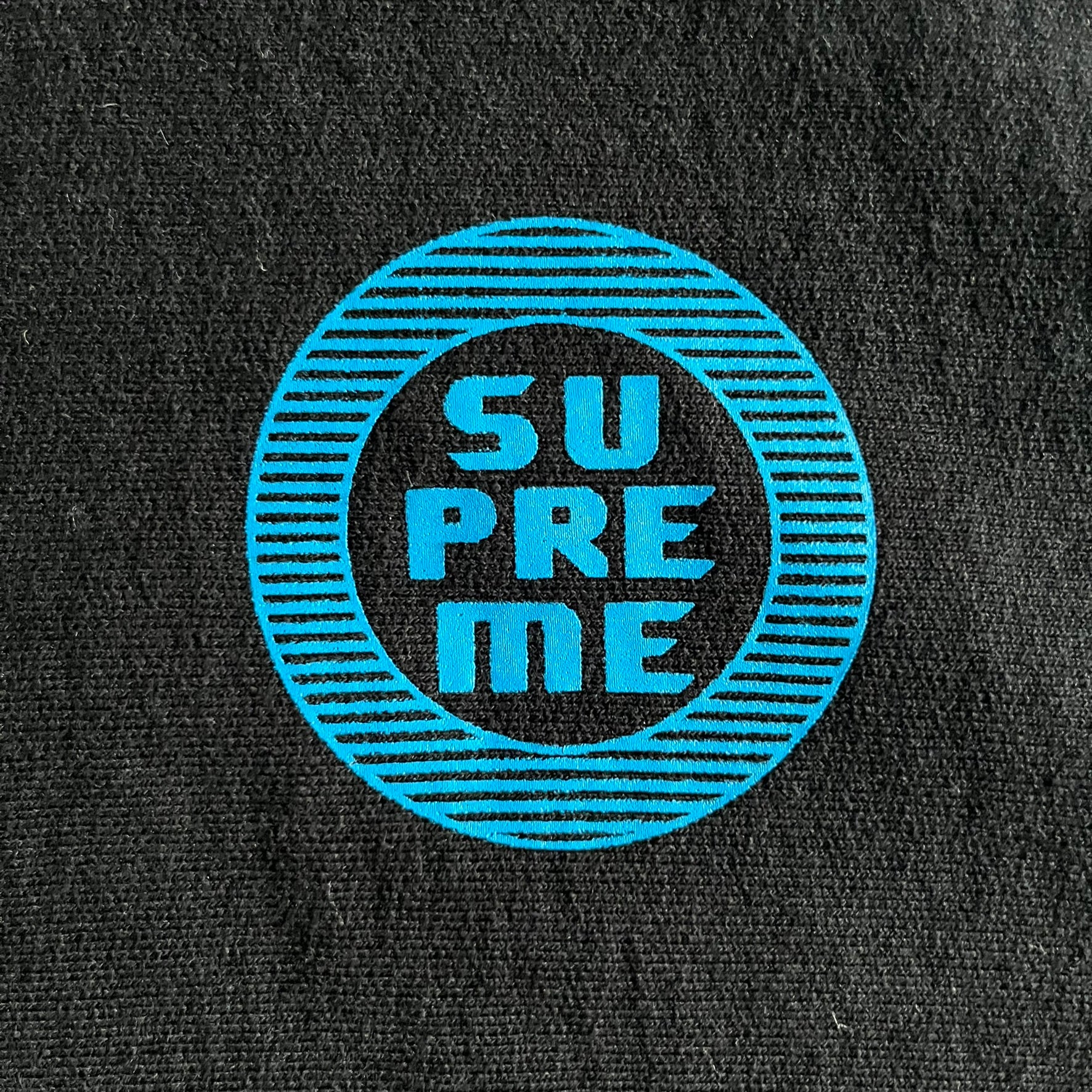 Released in Spring/Summer 2015, the Supreme Disrupt Hoodie in black features a minimalist front logo and a bold oversized back print. Made from 100% cotton, this piece delivers Supreme’s signature streetwear silhouette with durable rib-knit cuffs and hooded design.