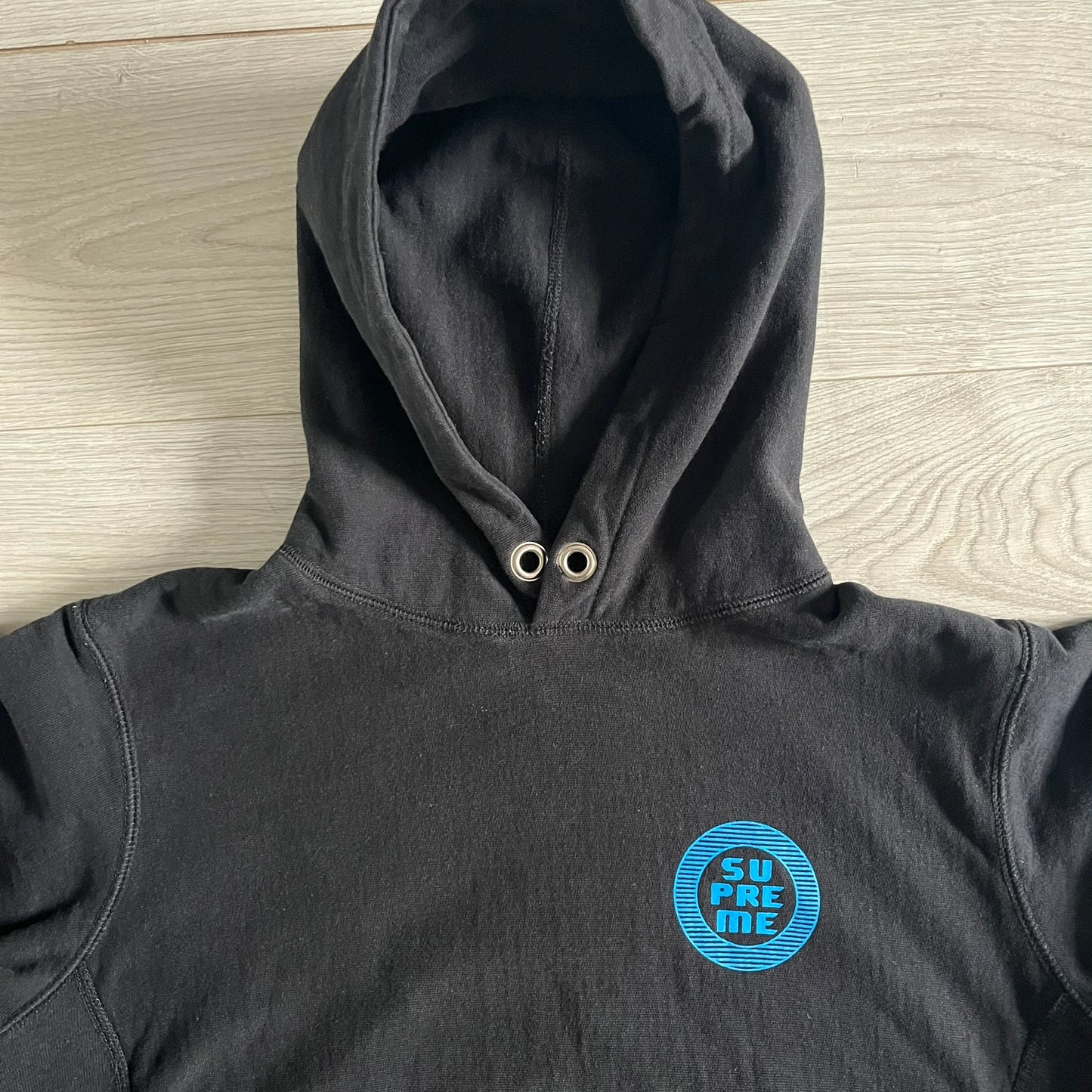 Released in Spring/Summer 2015, the Supreme Disrupt Hoodie in black features a minimalist front logo and a bold oversized back print. Made from 100% cotton, this piece delivers Supreme’s signature streetwear silhouette with durable rib-knit cuffs and hooded design.