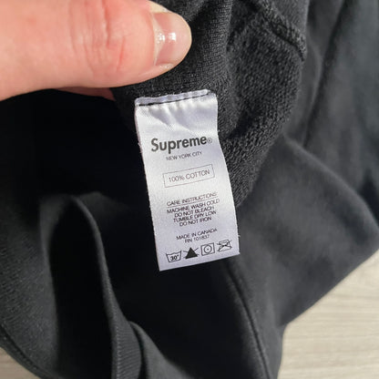 Released in Spring/Summer 2015, the Supreme Disrupt Hoodie in black features a minimalist front logo and a bold oversized back print. Made from 100% cotton, this piece delivers Supreme’s signature streetwear silhouette with durable rib-knit cuffs and hooded design.