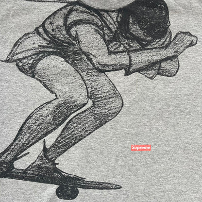 Supreme FW07 WTAPS “Live To Ride, Ride To Live” Gray Tee is a gray short-sleeve T-shirt released in Autumn/Winter 2007. The front features a black sketch of Robin on a skateboard with a small red Supreme logo beside it, while the upper back displays bold “Live To Ride, Ride To Live” text. The T-shirt was designed by Tetsu Nishiyama (WTAPS).