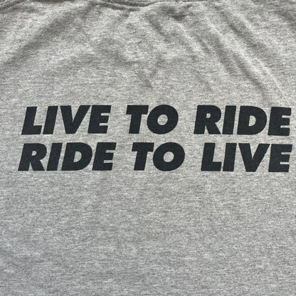 Supreme FW07 WTAPS “Live To Ride, Ride To Live” Gray Tee is a gray short-sleeve T-shirt released in Autumn/Winter 2007. The front features a black sketch of Robin on a skateboard with a small red Supreme logo beside it, while the upper back displays bold “Live To Ride, Ride To Live” text. The T-shirt was designed by Tetsu Nishiyama (WTAPS).
