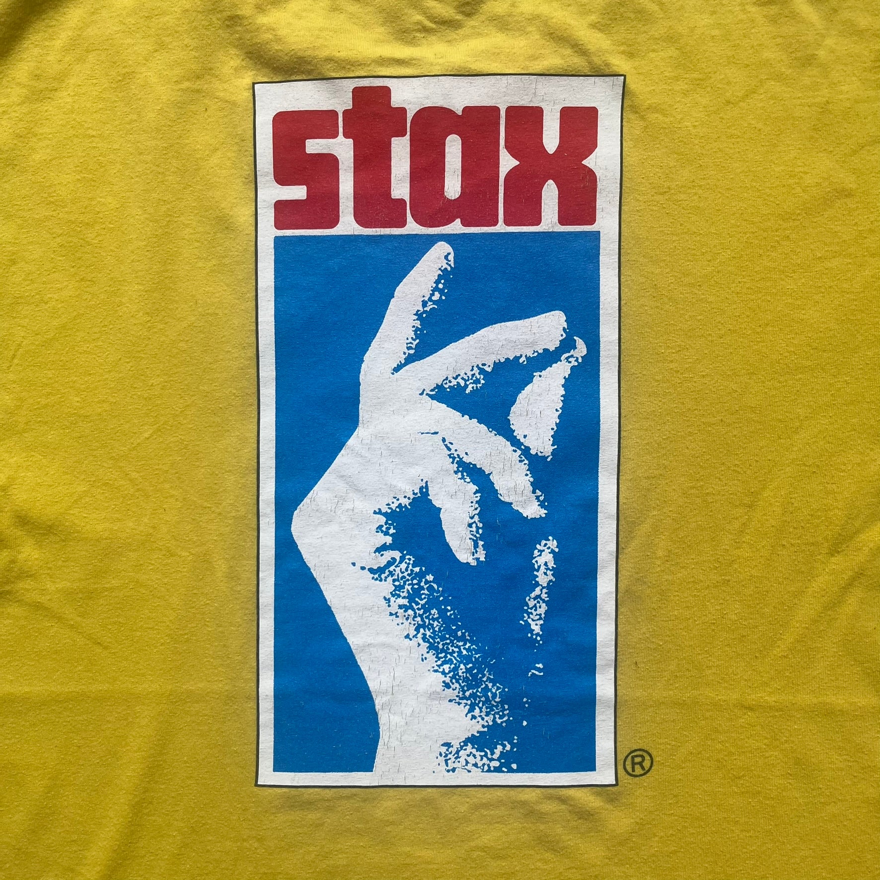 Supreme FW12 Stax Records Tee is a yellow T-shirt from the Fall/Winter 2012 collection. The front features small black Supreme text on the left chest. The back has a large Stax Records logo print with the blue and white hand graphic and red Stax text underneath. Concord Music Group licensing on the necktag.