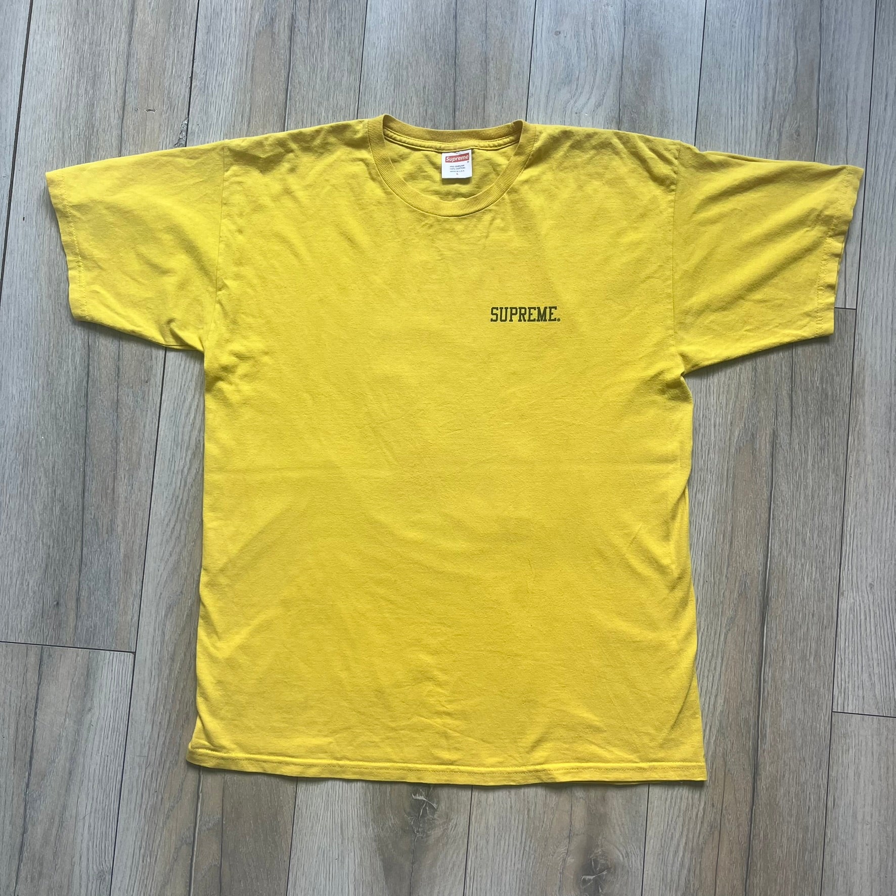 Supreme FW12 Stax Records Tee is a yellow T-shirt from the Fall/Winter 2012 collection. The front features small black Supreme text on the left chest. The back has a large Stax Records logo print with the blue and white hand graphic and red Stax text underneath. Concord Music Group licensing on the necktag.