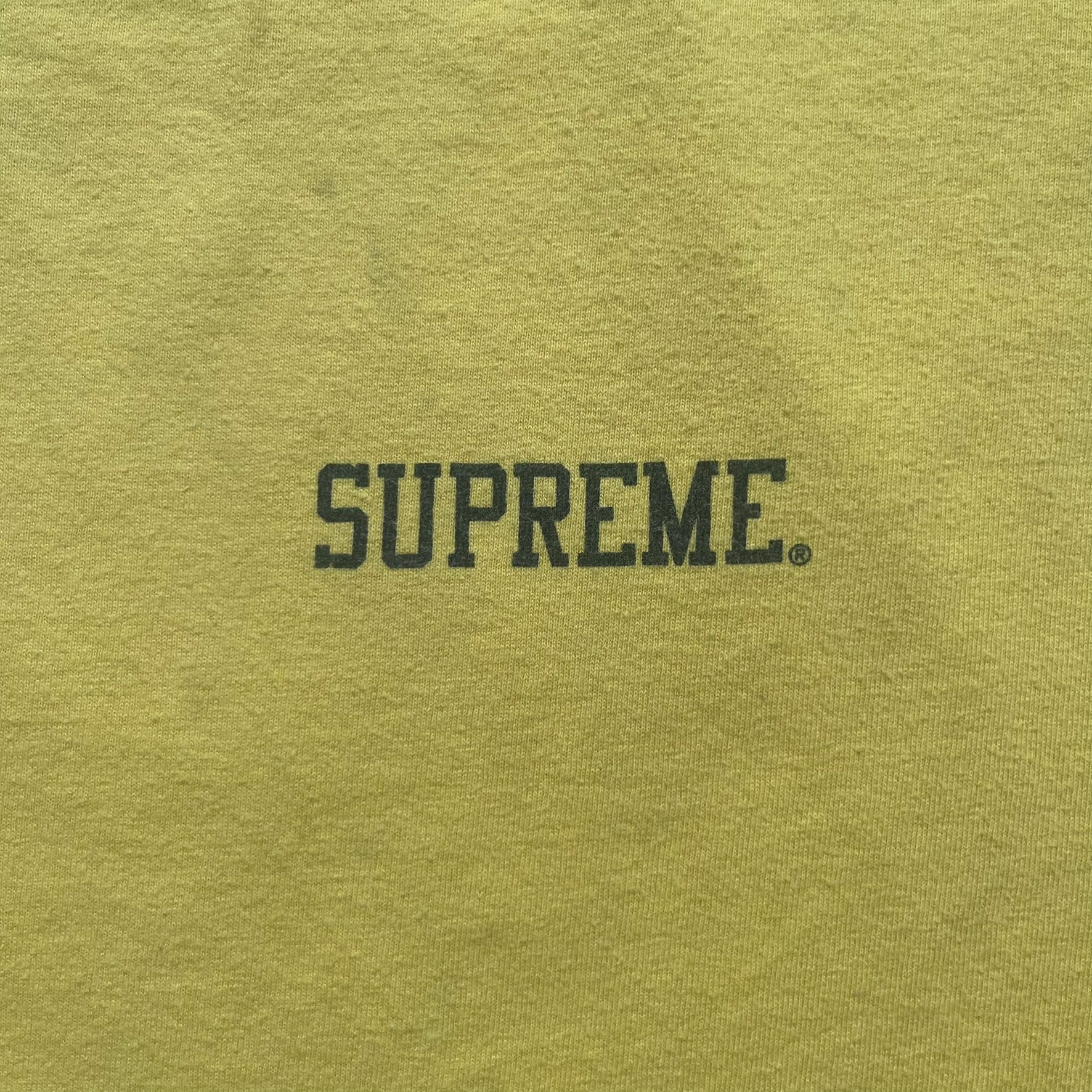 Supreme FW12 Stax Records Tee is a yellow T-shirt from the Fall/Winter 2012 collection. The front features small black Supreme text on the left chest. The back has a large Stax Records logo print with the blue and white hand graphic and red Stax text underneath. Concord Music Group licensing on the necktag.