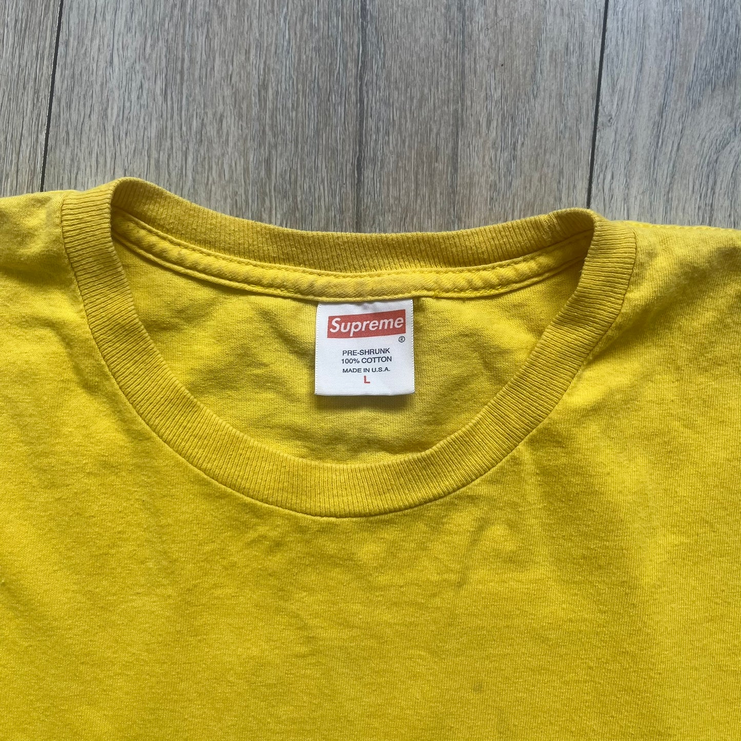 Supreme FW12 Stax Records Tee is a yellow T-shirt from the Fall/Winter 2012 collection. The front features small black Supreme text on the left chest. The back has a large Stax Records logo print with the blue and white hand graphic and red Stax text underneath. Concord Music Group licensing on the necktag.