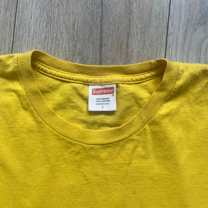 Supreme FW12 Stax Records Tee is a yellow T-shirt from the Fall/Winter 2012 collection. The front features small black Supreme text on the left chest. The back has a large Stax Records logo print with the blue and white hand graphic and red Stax text underneath. Concord Music Group licensing on the necktag.