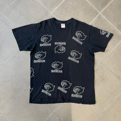 Supreme FW17 Gonz Heads Tee is a black T-shirt from the Fall/Winter 2017 collection created in collaboration with Mark Gonzales (The Gonz). The tee features repeated white Gonz head graphics printed across both the front and back in different orientations. The shirt is made in the USA.