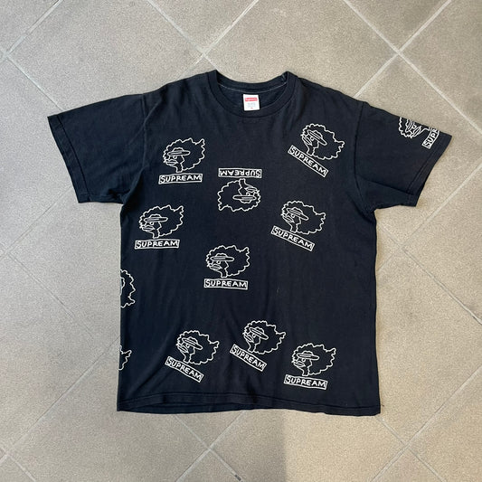 Supreme FW17 Gonz Heads Tee is a black T-shirt from the Fall/Winter 2017 collection created in collaboration with Mark Gonzales (The Gonz). The tee features repeated white Gonz head graphics printed across both the front and back in different orientations. The shirt is made in the USA.