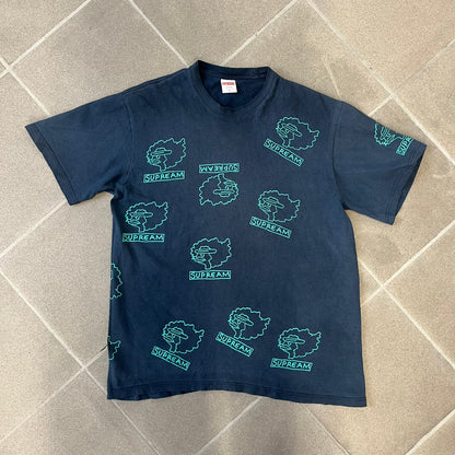 Supreme FW17 Gonz Heads Tee is a navy T-shirt from the Fall/Winter 2017 collection created in collaboration with Mark Gonzales (The Gonz). The tee features repeated green Gonz head graphics printed across both the front and back in different orientations. The shirt is made in the USA.
