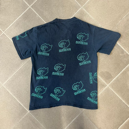 Supreme FW17 Gonz Heads Tee is a navy T-shirt from the Fall/Winter 2017 collection created in collaboration with Mark Gonzales (The Gonz). The tee features repeated green Gonz head graphics printed across both the front and back in different orientations. The shirt is made in the USA.
