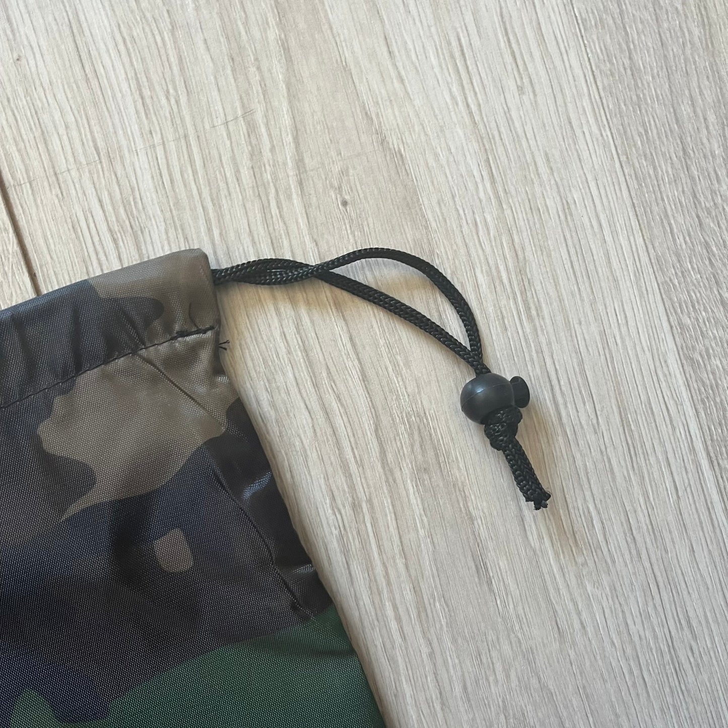 Supreme FW25 Woodland Camo laundry bag in Realtree AP camouflage, released as a limited gift during the first drop of the Fall/Winter 2025 season. Features 190 Bowery New York contact details, “Free Pick-up &amp; Delivery” text, and the iconic Supreme Box Logo on the top.