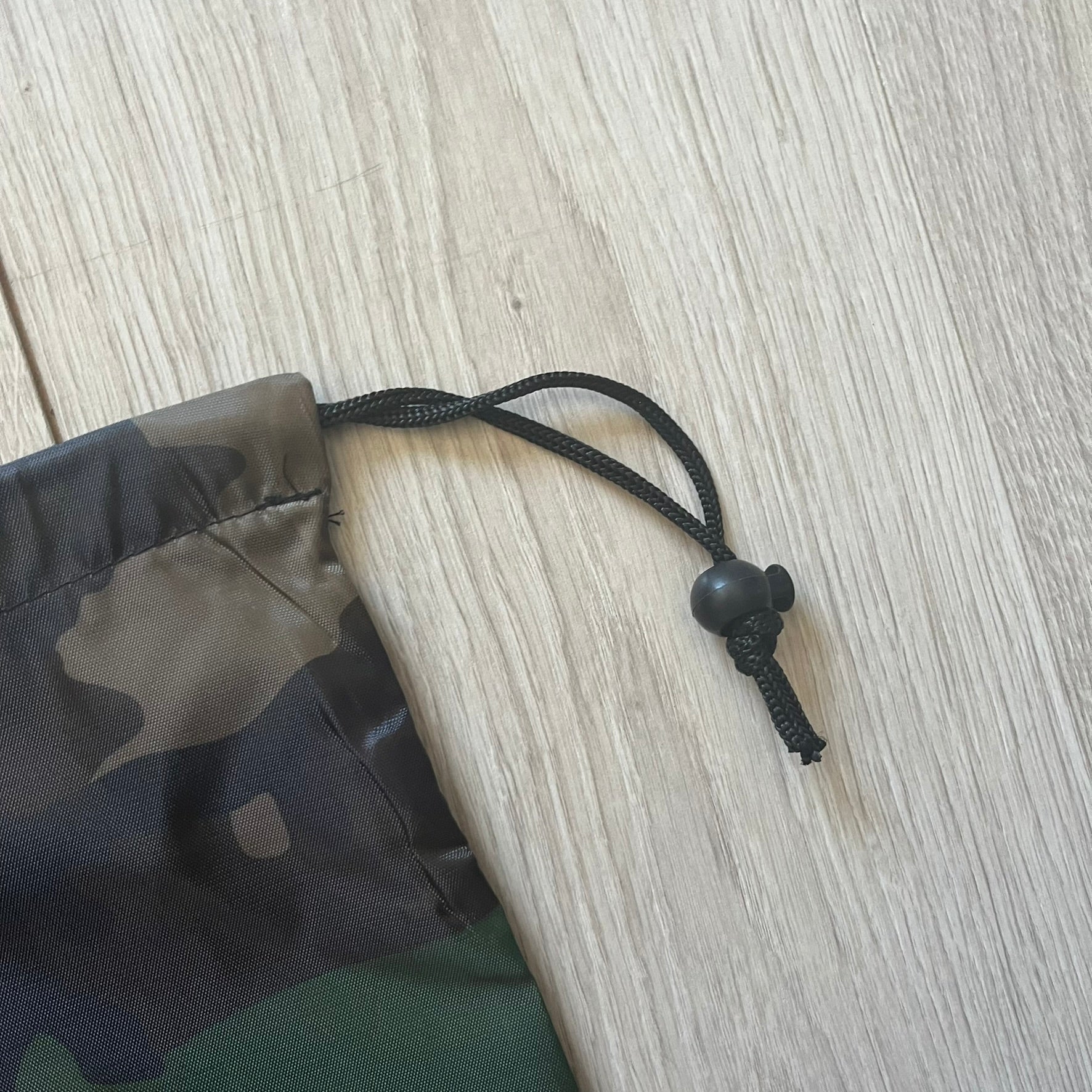Supreme FW25 Woodland Camo laundry bag in Realtree AP camouflage, released as a limited gift during the first drop of the Fall/Winter 2025 season. Features 190 Bowery New York contact details, “Free Pick-up &amp; Delivery” text, and the iconic Supreme Box Logo on the top.