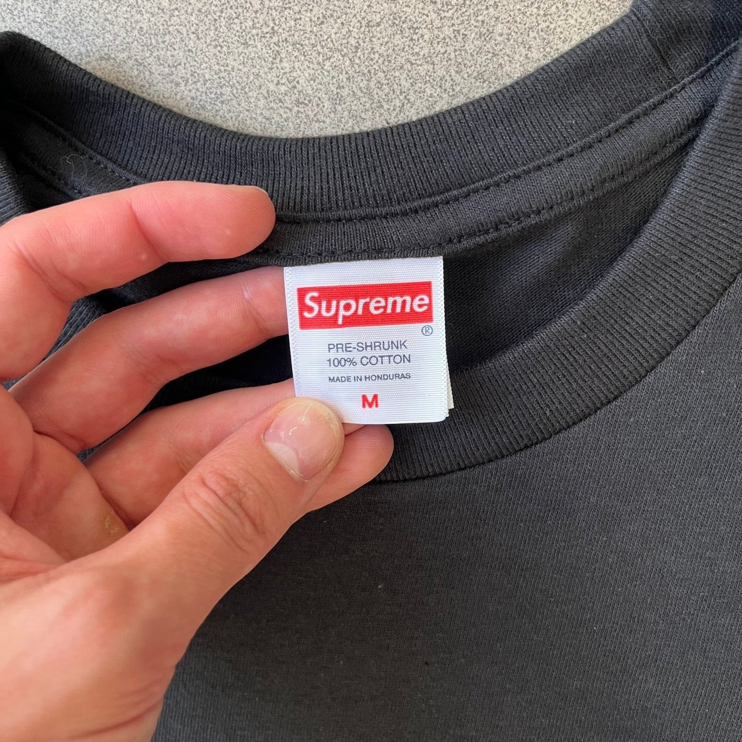 Supreme FW26 Darth Maul Sith Black Tee features a black 100% cotton T-shirt with a photo graphic of Darth Maul on a blue background. A white Supreme logo is printed above the graphic. Features a licensed Star Wars neck tag and is made in Honduras.
