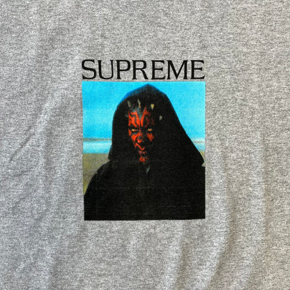 Supreme FW26 Darth Maul Sith Gray Tee features a black 90% cotton and 10% polyester T-shirt with a photo graphic of Darth Maul on a blue background. A white Supreme logo is printed above the graphic. Features a licensed Star Wars neck tag and is made in Honduras.
